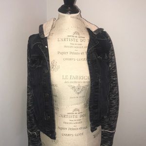 Distressed denim jacket with attached knit sleeves